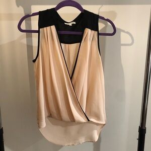 Elegant Sleeveless Drape Front Blouse in Black and Cream
